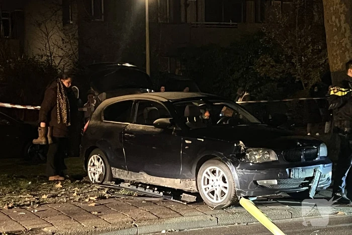 Automobilist ramt lantaarnpaal en elektriciteitskast