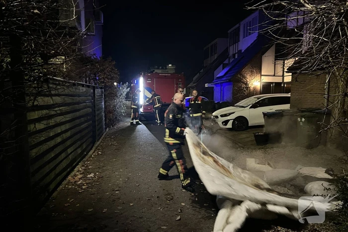 Brandende deken geblust met emmer water