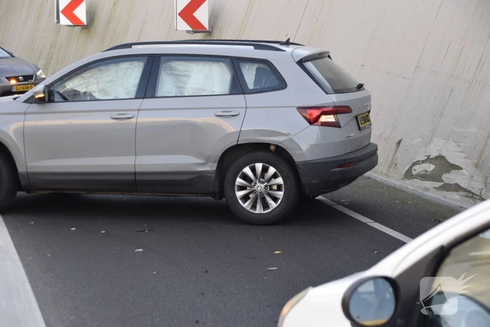 Twee auto's botsen onder spoortunnel
