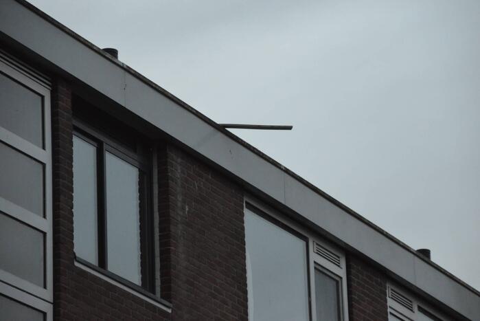 Stuk daklijst dreigt van gebouw te waaien