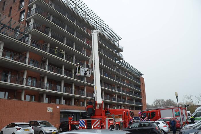 Zwarte rookwolk bij brand in flatwoning