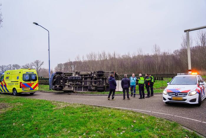 Bestelbus kantelt en belandt in sloot