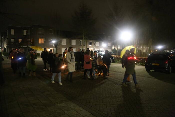 Groep mensen loopt lichtjestocht tegen coronamaatregelen