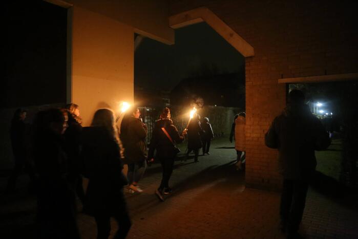 Groep mensen loopt lichtjestocht tegen coronamaatregelen