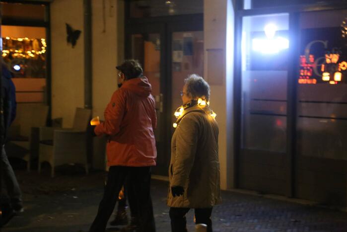 Groep mensen loopt lichtjestocht tegen coronamaatregelen