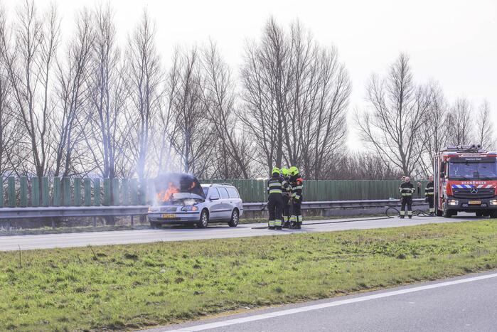 Personenwagen vliegt onder het rijden in brand