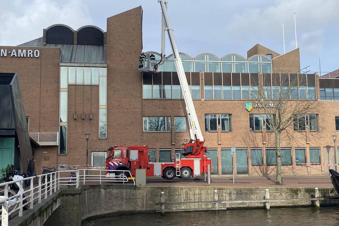 Brandweer verwijderd losgekomen dakbedekking