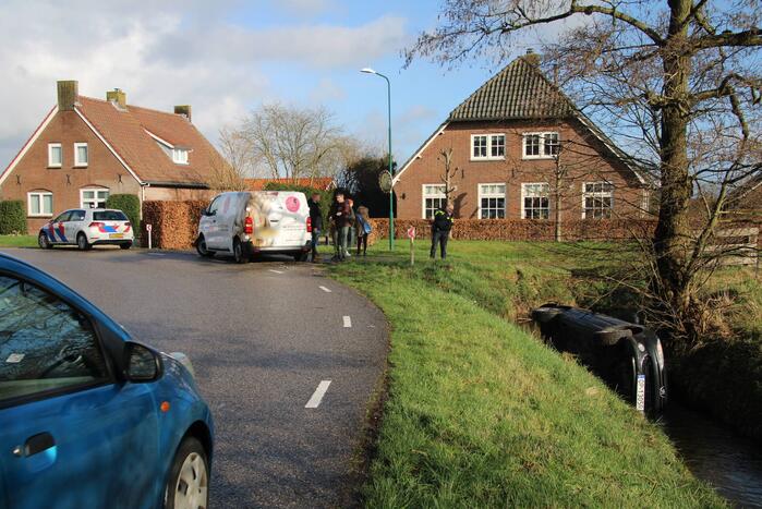 Auto belandt op kant in sloot