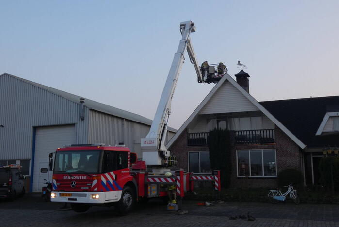 Brandweer blust brand in schoorsteen