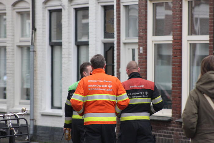 Adviseur van de brandweer doet onderzoek naar vreemde lucht in woning