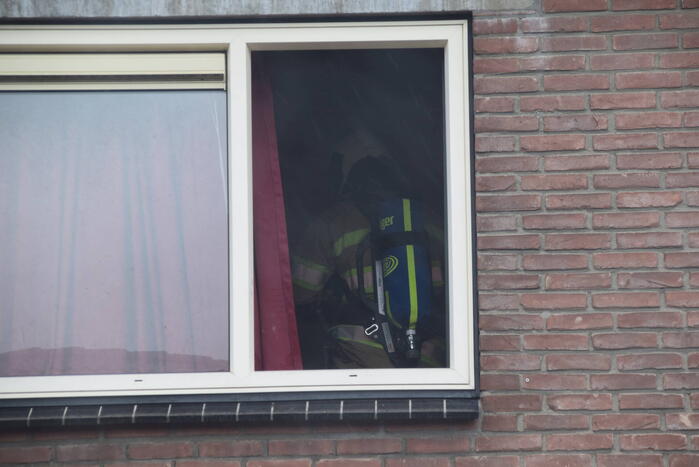 Wasmachine in woning vat vlam