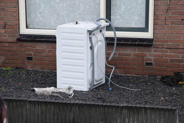 Wasmachine in woning vat vlam