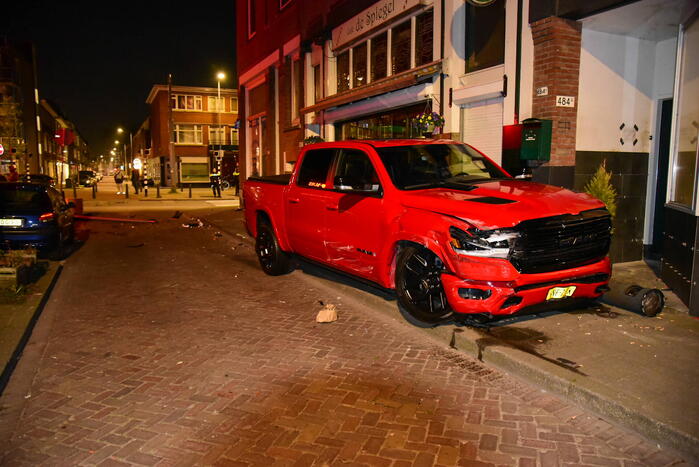 Auto knalt tegen winkelpand door botsing