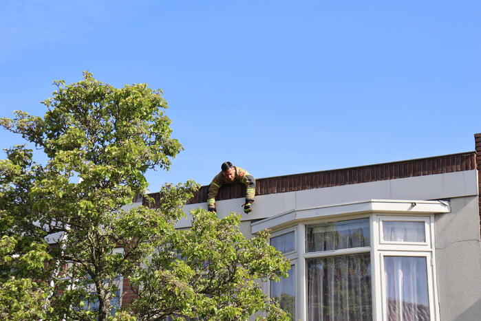 Brandweer veegt schoorsteen na brand