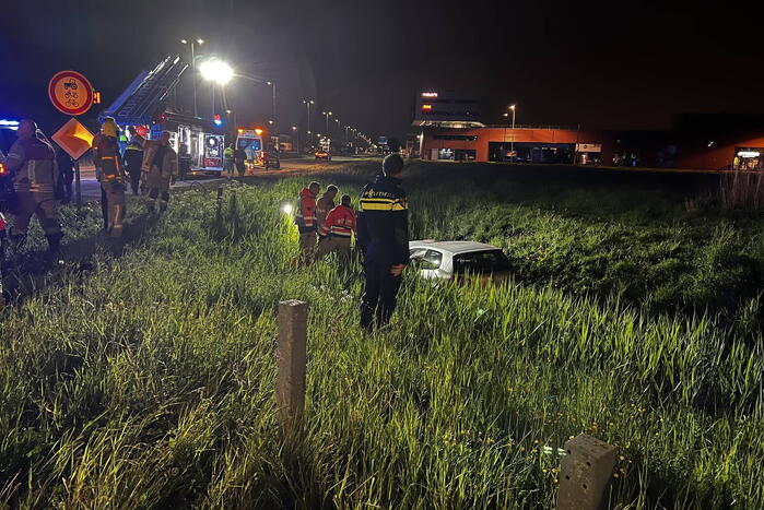 Brandweer redt persoon in voertuig uit sloot