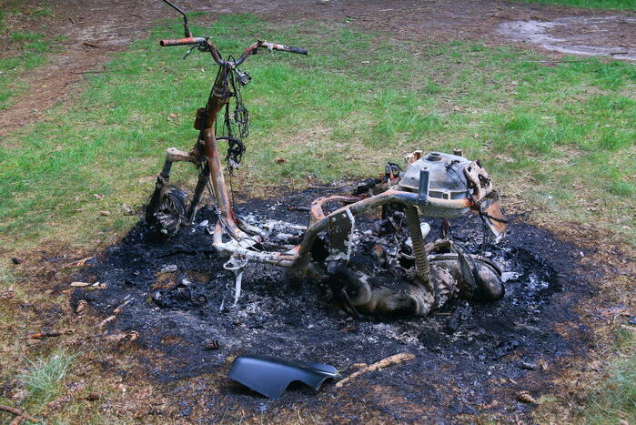 Onderzoek naar uitgebrande scooter in bosgebied