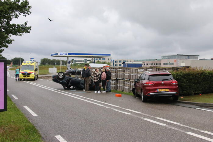 Auto over de kop bij botsing