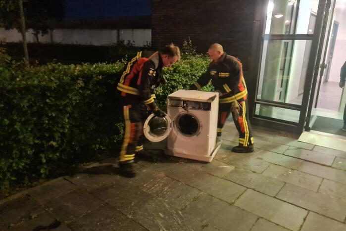 Brand in flat door wasmachine