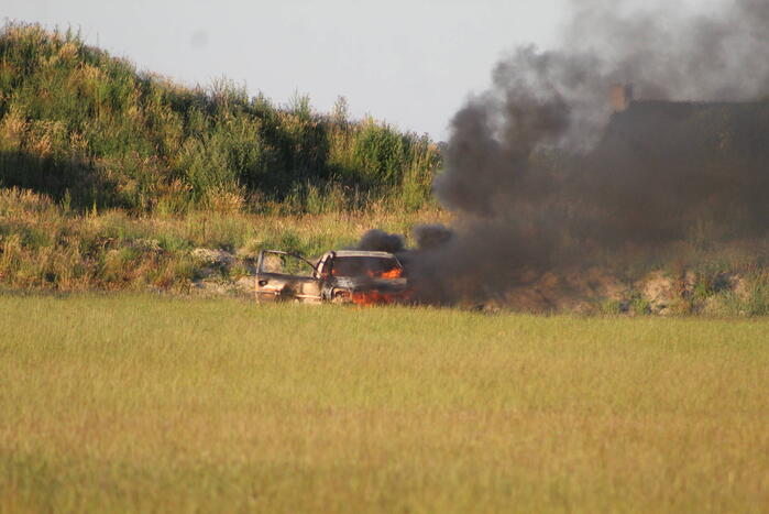 Auto midden in het veld verwoest vanwege brand