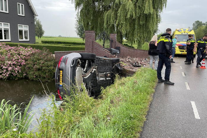 Auto knalt door muur en belandt in het water