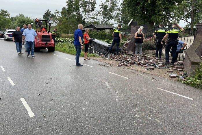 Auto knalt door muur en belandt in het water
