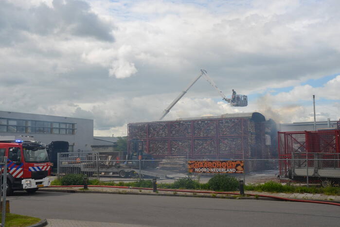 Uitslaande brand in gestapelde haardhout-boxen