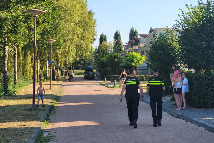 Brandweer blust bermbrand naast treinspoor