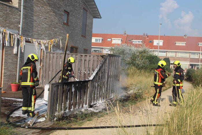 Schutting van woning vat vlam