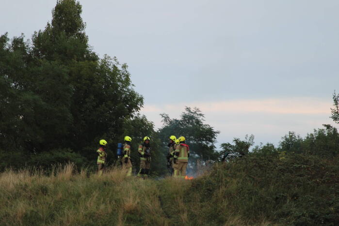 Pallets boven op berg in brand gevlogen