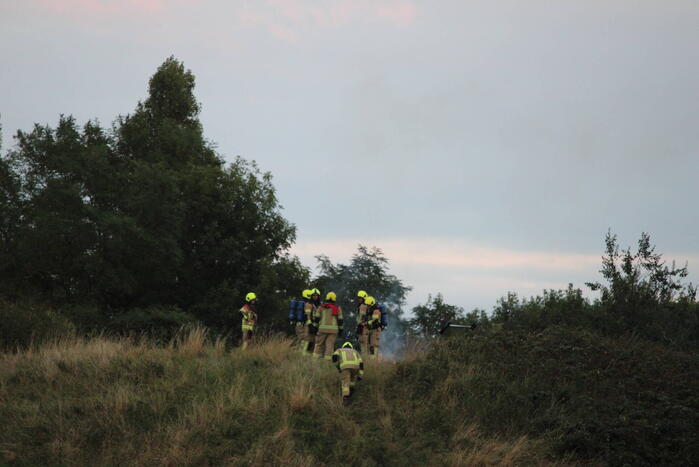 Pallets boven op berg in brand gevlogen