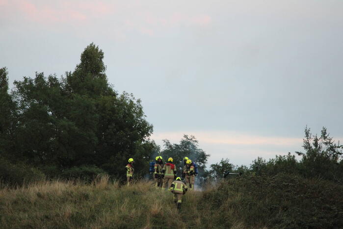 Pallets boven op berg in brand gevlogen