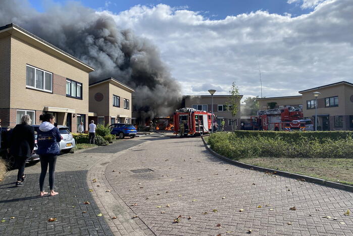 Enorme vlammen en rookwolken bij woningbrand