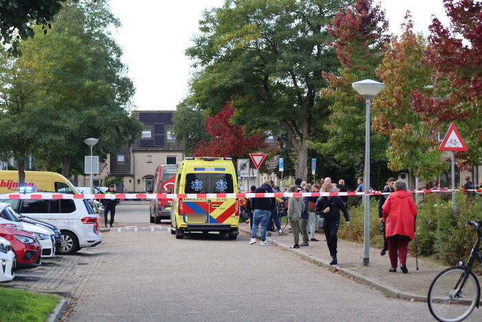 Persoon belandt onder bestelbus