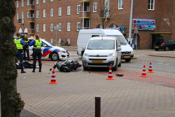 Afslaande bestelbus ziet scooterrijder over het hoofd