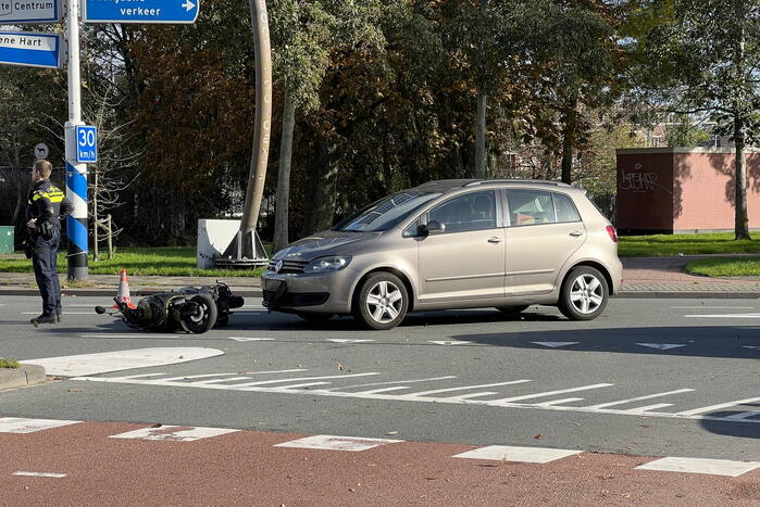 Personenauto ziet scooterrijder over het hoofd