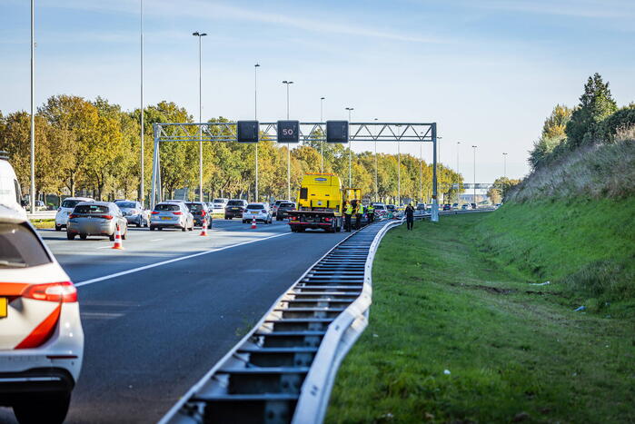 Automobilist verliest overbeladen aanhangwagen met pallets en crasht