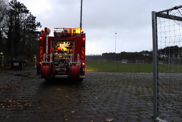 Wasmachine in brand tegen gebouw