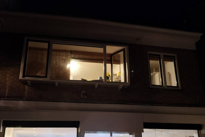 Brand in bergruimte boven winkel