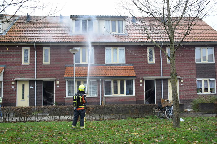 Veel rook uit dakkapel bij woningbrand