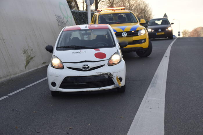 Twee auto's botsen onder spoortunnel