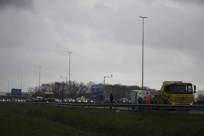 Auto met aanhanger geschaard op snelweg