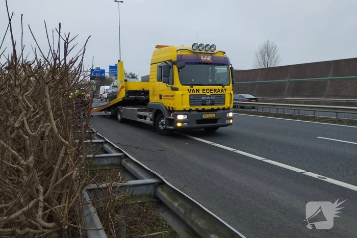 Personenauto klapt bovenop vrachtwagen