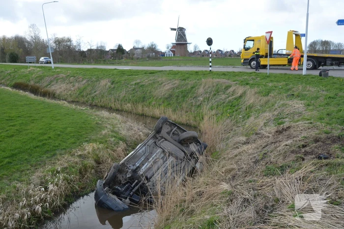 Bestelbus belandt in de sloot na botsing met auto