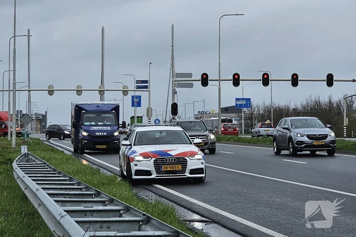 Politie bewaakt geldwagen met lekke band