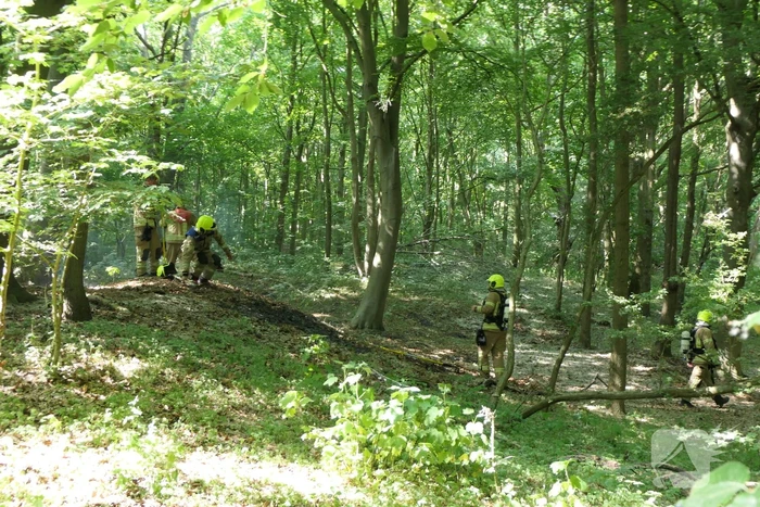Brandweer blust smeulende delen in duingebied