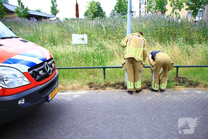 Berm in brand bij winkelcentrum