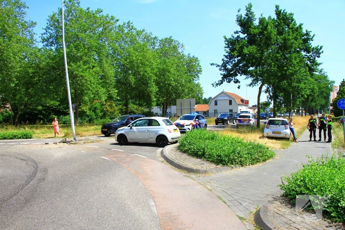 Automobilist ramt paal en lantaarnpaal bij rotonde