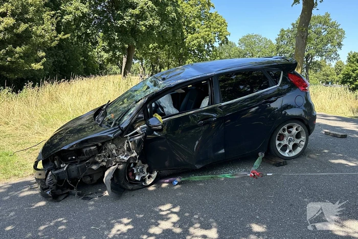 Auto belandt op de kop na botsing tegen boom