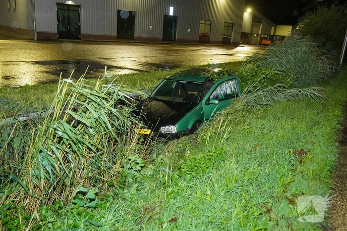 Auto glijdt de bocht uit in een sloot