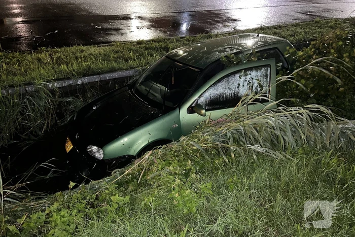 Auto glijdt de bocht uit in een sloot